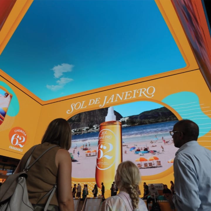 Sol De janeiro DOOH ad with people surrounding it.