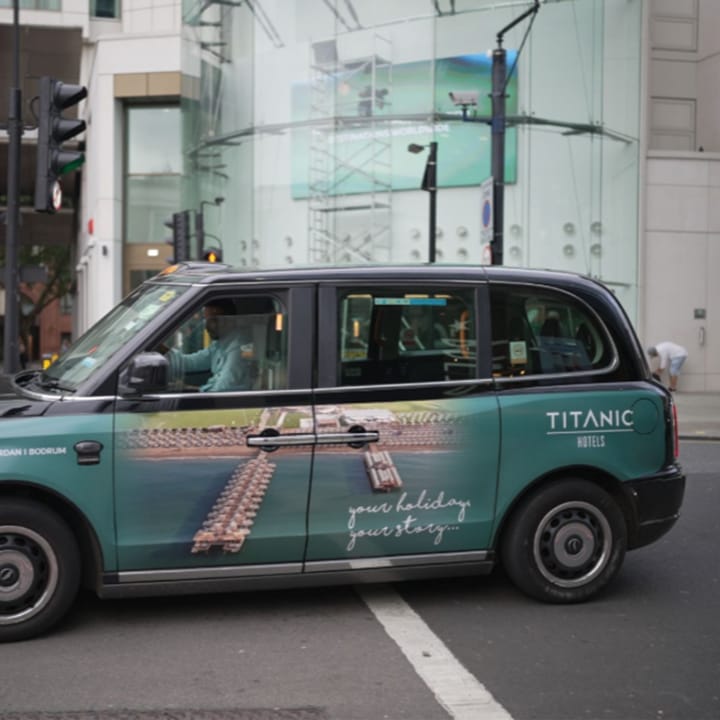 Black cab with an ad.