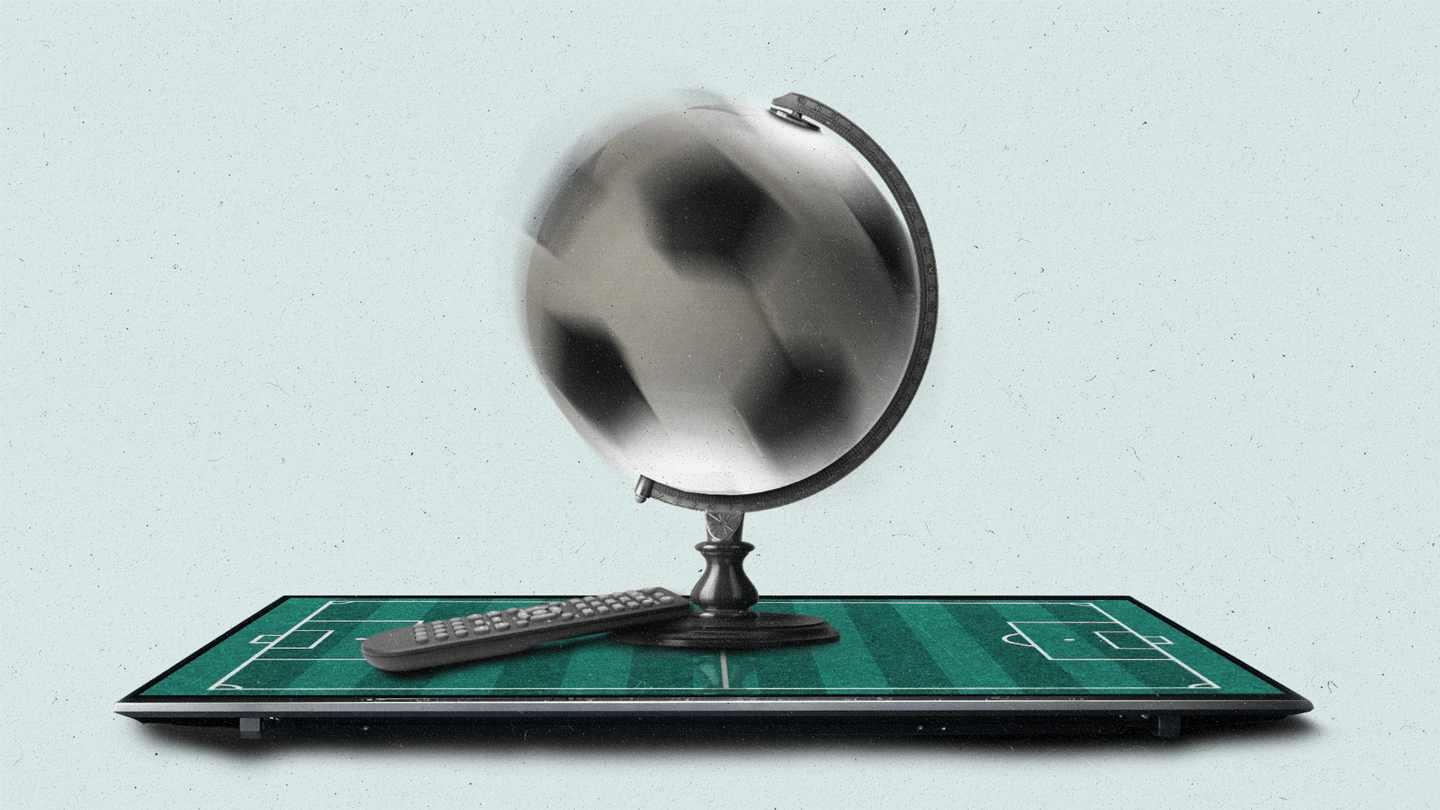 A globe with a spinning soccer ball sits on a TV with soccer field on screen