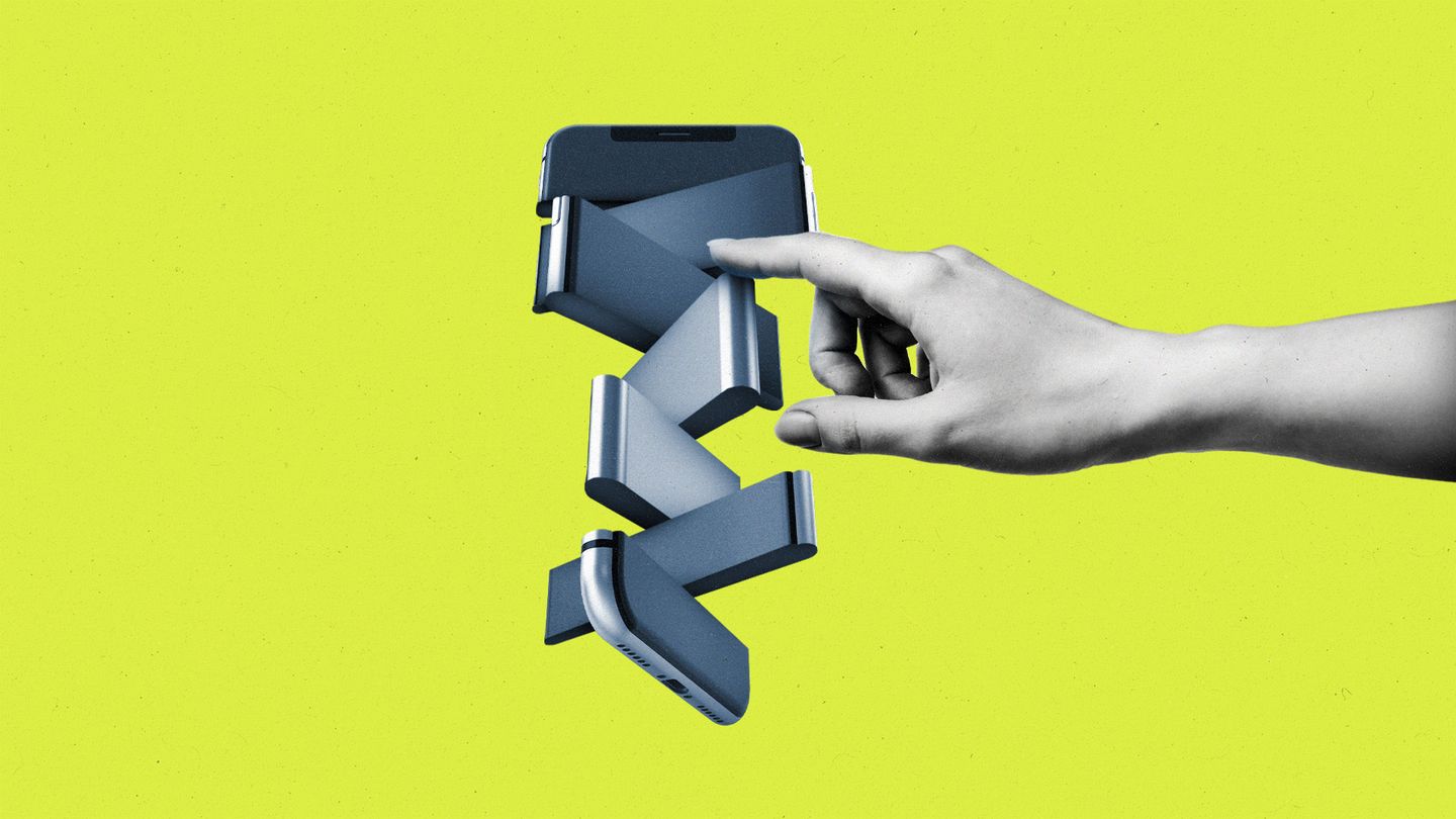 Hand pushing pieces of a fragmented and spinning smartphone