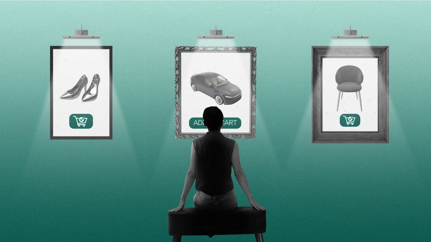 Person sitting in a gallery looking at framed ads on the wall.