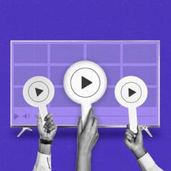Three hands hold auction paddles with play buttons in front of a Connected TV.