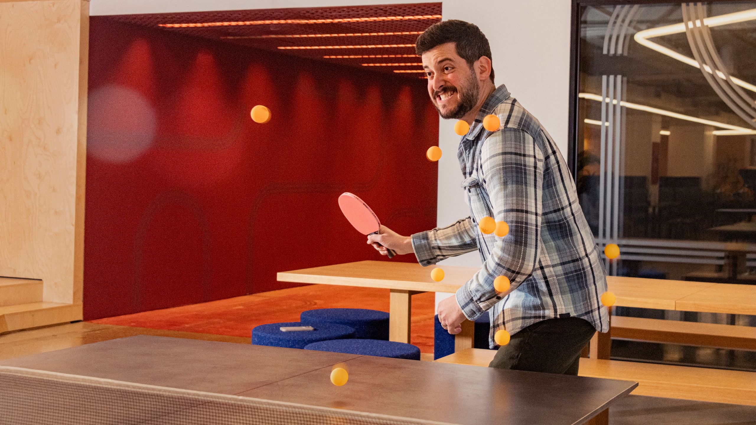Man playing table tennis in modern office recreation area