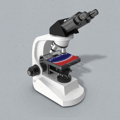 A microscope with a political yard sign resembling a sample slide.