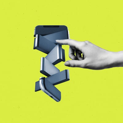 Hand pushing pieces of a fragmented and spinning smartphone