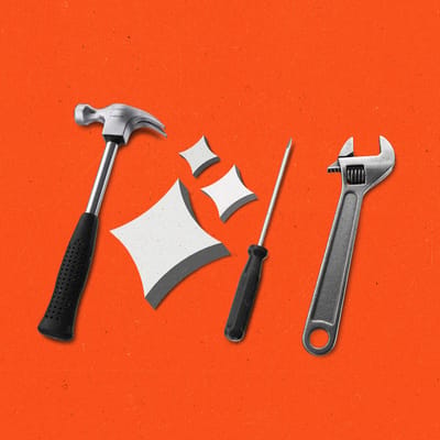 Tools, a hammer, screwdriver, wrench and AI sparkles, all lying in a row.