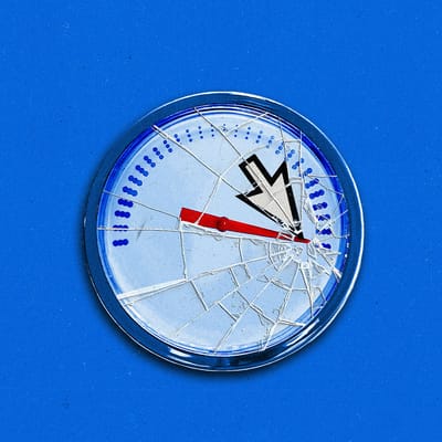 A speedometer maxed out, with a broken glass face.