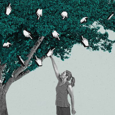 A woman reaches up a picks a finger cursor off of a tree.