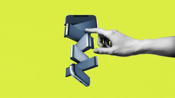 Hand pushing pieces of a fragmented and spinning smartphone
