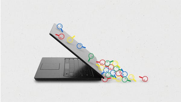 Pixelated magnifying glass icons in red, blue, yellow and green sliding down the back of a laptop, landing in a pile.