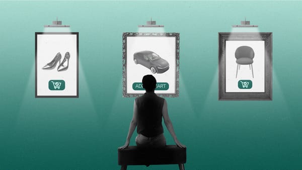 Person sitting in a gallery looking at framed ads on the wall.