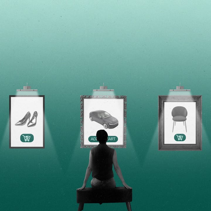 Person sitting in a gallery looking at framed ads on the wall.